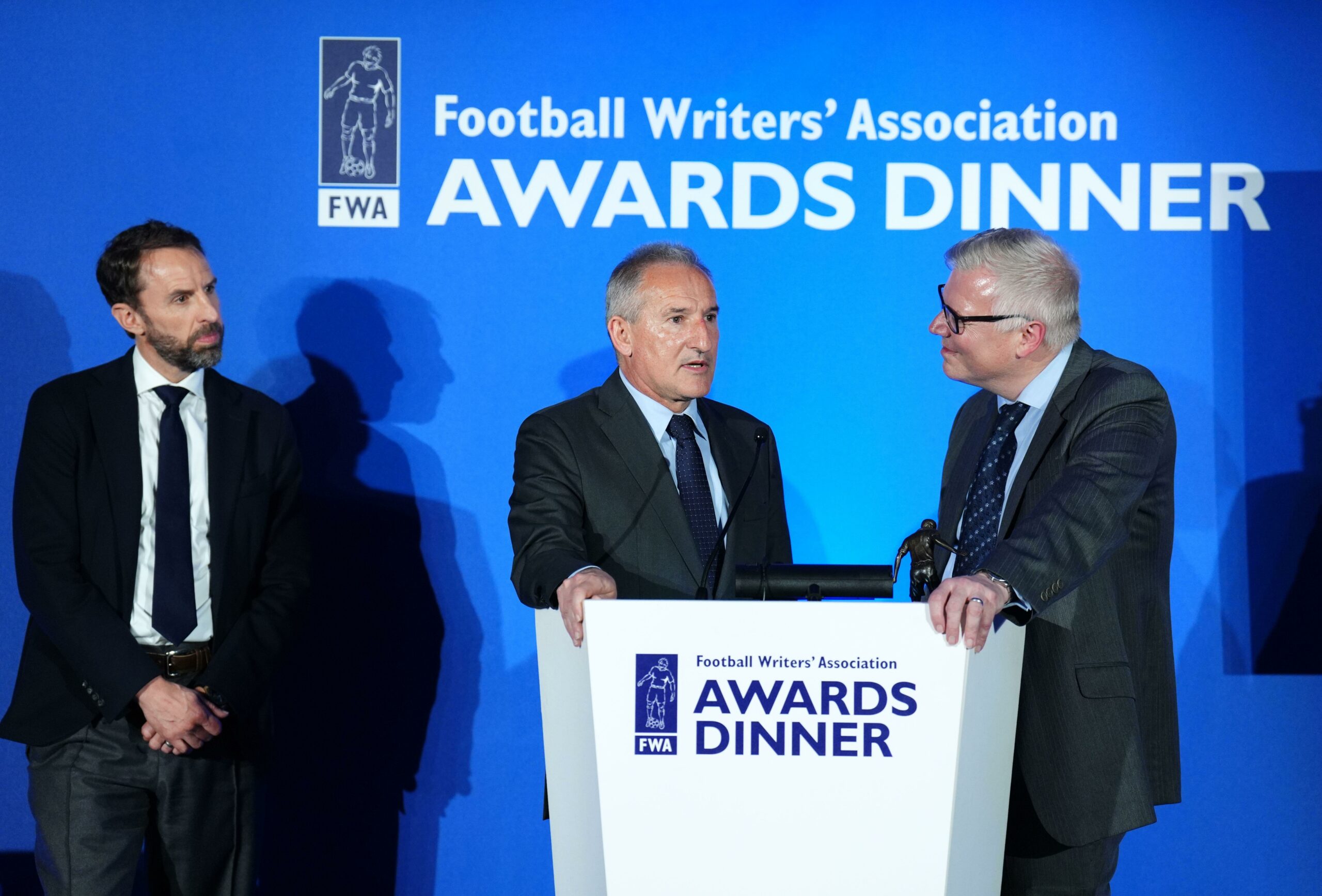 Manchester City Director of Football Txiki Begiristain (centre) speaks after receiving the FWA Men's Footballer of the Year trophy on behalf of Phil Foden, alongside Chairman of the FWA John Cross (right) and England manager Gareth Southgate during the FWA Footballer of the Year awards held at the Landmark Hotel, London. Picture date: Thursday May 16, 2024.