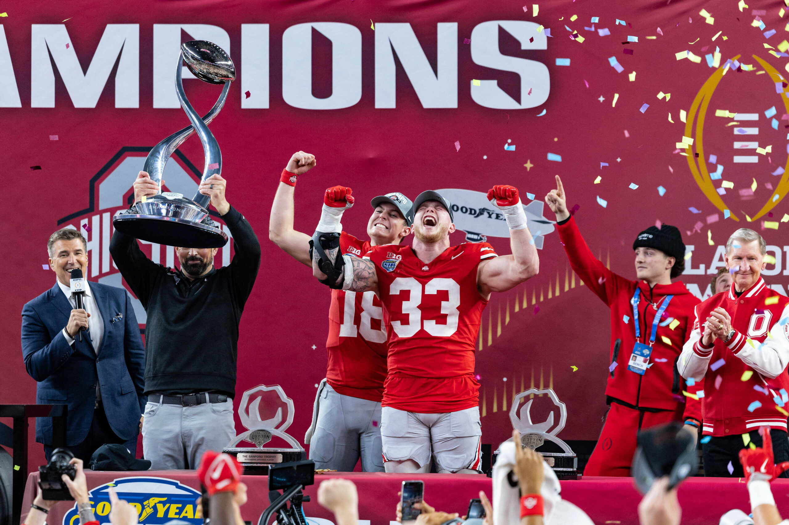 ARLINGTON, TX - JANUARY 10: Ohio State Buckeyes head coach Ryan Day, quarterback Will Howard (#18), and defensive end Jack Sawyer (#33) celebrate on the stage after the CFP Semifinal Cotton Bowl Classic football game between the Ohio State Buckeyes and Texas Longhorns on January 10, 2025 at AT&T Stadium in Arlington, TX. (Photo by Matthew Visinsky/Icon Sportswire) (Icon Sportswire via AP Images)