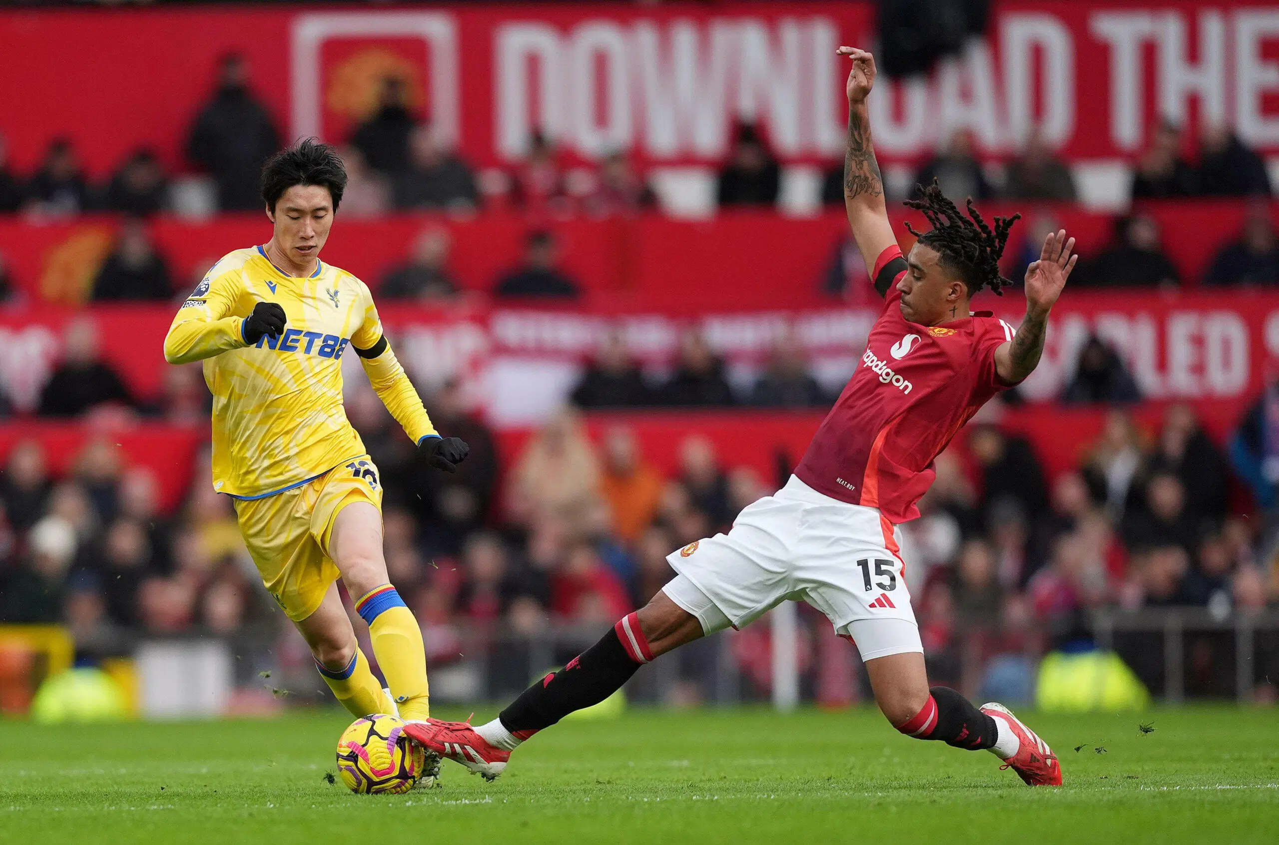 Crystal Palace's Daichi Kamada (left) is tackled by Manchester United's Leny Yoro during the Premier League match at Old Trafford, Manchester. Picture date: Sunday February 2, 2025.