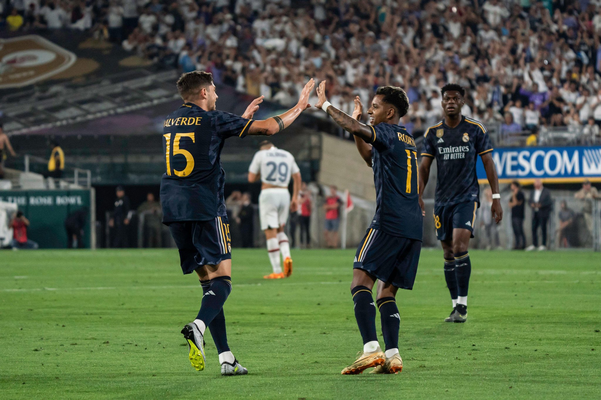 Real Madrid midfielder Federico Valverde (15) celebrates a goal with forward Rodrygo Silva (11) during the Soccer Champions Tour against AC Milan, Sun