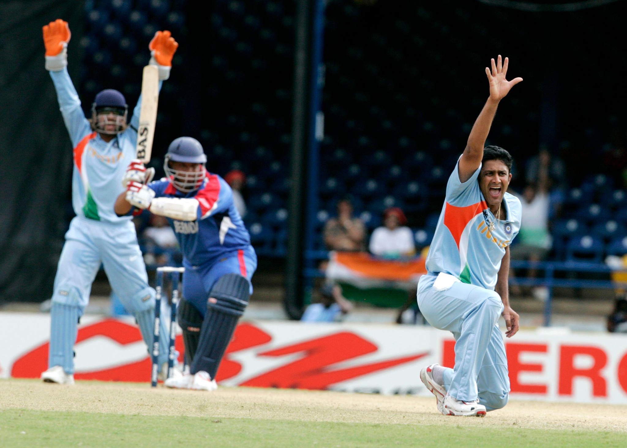India's Anil Kumble, right, makes a successful LBW appeal on Bermuda's Irving Romaine, center, during the Group B Cricket World Cup match between India and Bermuda at the Queen's Park Oval in Port-of-Spain, Trinidad Monday, March 19, 2007. At left is India's wicket keeper Mahendra Dhoni. (AP Photo/Lynne Sladky)