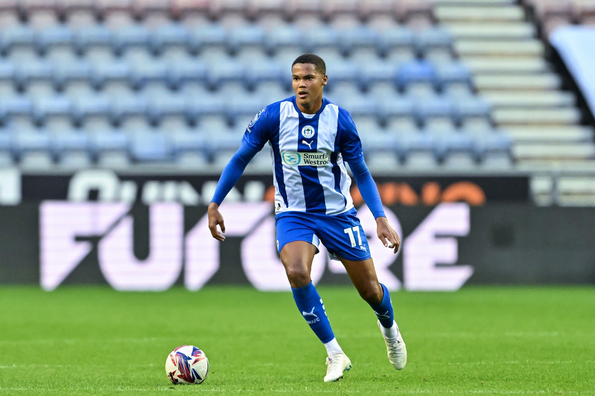 Michael Olakigbe of Wigan Athletic in action during the Bristol Street Motors Trophy match Wigan Athletic vs Morecambe at DW Stadium, Wigan, United Kingdom, 3rd September 2024 (Photo by Cody Froggatt/News Images)