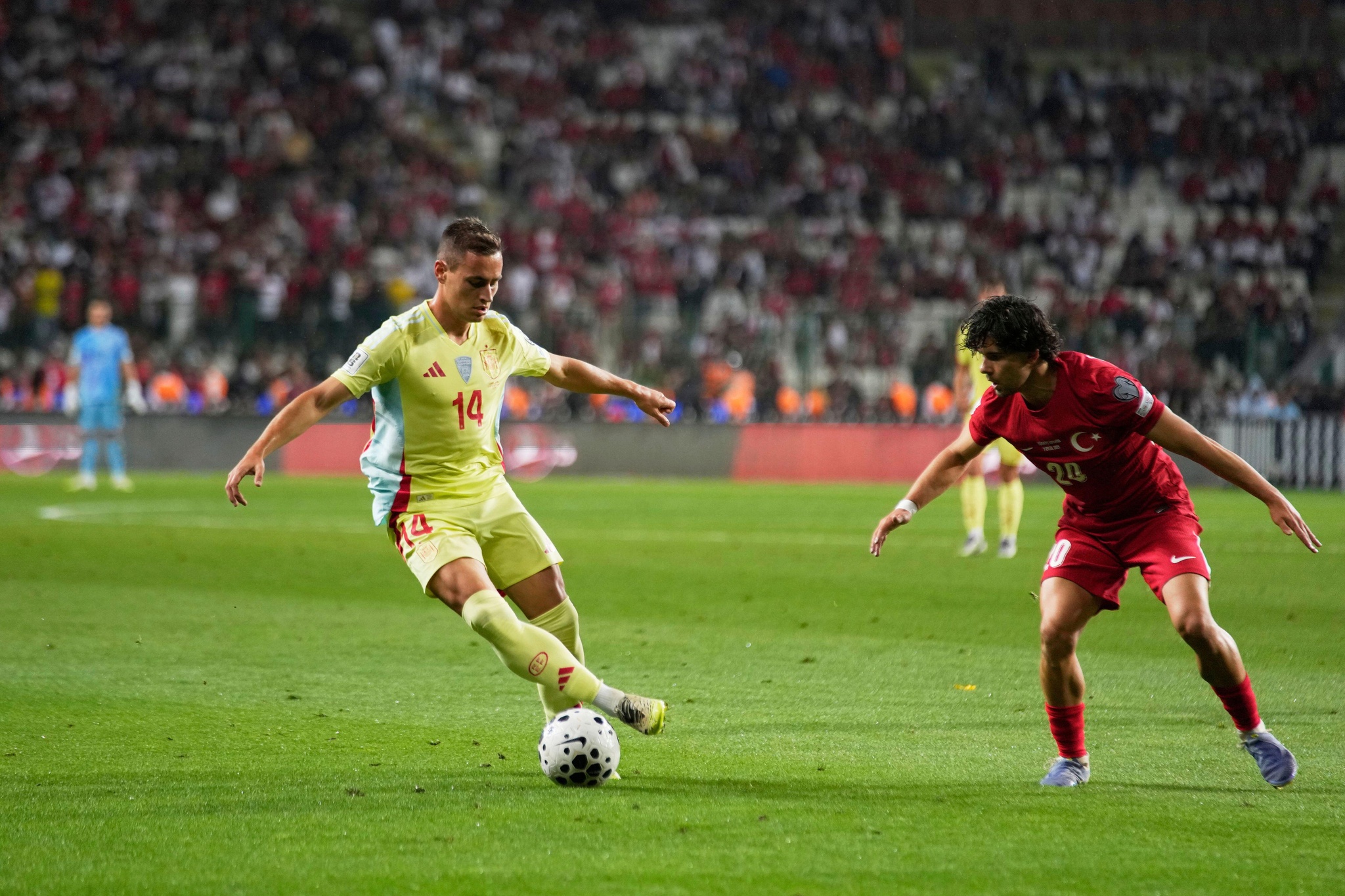Spain's Jorge De Frutos, left, dribbles the ball past Turkey's Ferdi Kadioglu during a World Cup qualifying round Group E soccer match between Turkey and Spain at Konya Buyuksehir stadium, in Konya, Turkey, Sunday, Sept. 7, 2025. (AP Photo/Khalil Hamra)