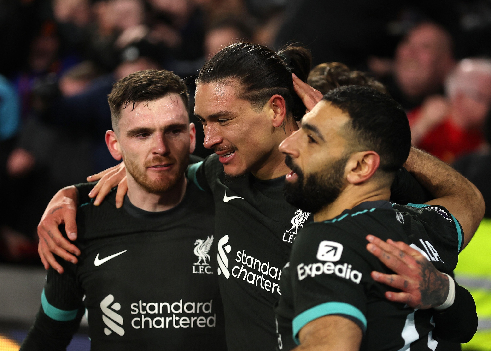 18th January 2025; Gtech Community Stadium, Brentford, London, England; Premier League Football, Brentford versus Liverpool; Darwin Nunez of Liverpool celebrates with Mohamed Salah and Andy Robertson of Liverpool towards the Liverpool fans after scoring his sides 2nd goal in the 93rd minute to make it 0-2